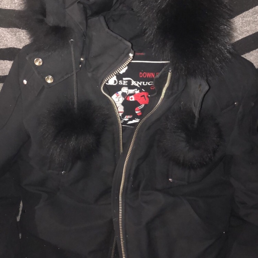 Moose knuckle women’s jacket with pom poms